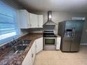 Well-lit kitchen featuring granite countertops and stainless steel appliances at 727 Queens Ave, Dunn, NC 28334