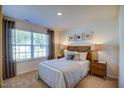 Cozy bedroom featuring a large window, plush carpeting, and tasteful decor at 7461 Michelle Rd, Rocky Mount, NC 27803