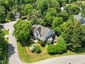 Aerial view of a home nestled among lush trees, showcasing its roofline, surrounding greenery, and neighborhood layout at 100 Michaels Way, Chapel Hill, NC 27516