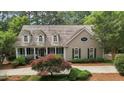 Picturesque home showcasing classic architecture, mature landscaping, and a welcoming front entrance at 1009 Bearglades Ln, Raleigh, NC 27615