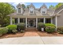 Inviting front entrance with a classic door, brick steps, and lush landscaping for a welcoming appeal at 1009 Bearglades Ln, Raleigh, NC 27615