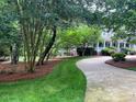 Manicured front lawn and landscaping leading to a charming home with a welcoming entrance at 1009 Bearglades Ln, Raleigh, NC 27615
