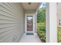 Welcoming front porch with a friendly 'hello' mat and a secure glass storm door at 1022 Flagler St, Durham, NC 27713