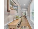Inviting entryway with a light wood floor and elegant wainscoting accents at 1022 Flagler St, Durham, NC 27713