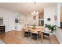 Bright dining area featuring hardwood floors, modern lighting, and stylish staircase at 103 Harrington Pt, Chapel Hill, NC 27516