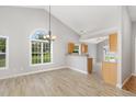 Bright dining area featuring wood laminate floors, neutral paint, and lots of natural light at 103 Rama Ct, Morrisville, NC 27560