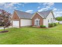 Spacious home featuring manicured lawn, a two-car garage, and a serene backyard at 103 Rama Ct, Morrisville, NC 27560