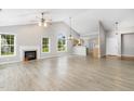 Bright, open living room with vaulted ceilings, fireplace, and wood laminate flooring at 103 Rama Ct, Morrisville, NC 27560