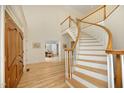 Grand foyer with a sweeping staircase, hardwood floors, and views into the dining area at 107 Silo Dr, Chapel Hill, NC 27514