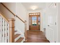 Bright foyer with hardwood floors, wood front door, and white trim at 11 Little Gem Ln, Fuquay Varina, NC 27526