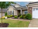 Charming single-Gathering home with manicured landscaping, stone accents, and a two-car garage at 112 Tanoak Ct, Durham, NC 27703