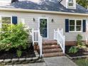 Inviting front entrance with brick steps and well-manicured landscaping at 113 Honeysuckle Ln, Durham, NC 27703