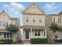 Attractive home with a charming porch, complemented by lush green landscaping at 113 Windy Creek Ln, Apex, NC 27502