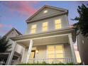 Inviting two-story home with a cozy front porch, perfect for relaxing evenings at 113 Windy Creek Ln, Apex, NC 27502