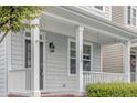Welcoming front porch features classic columns and well-maintained landscaping at 113 Windy Creek Ln, Apex, NC 27502