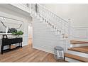 Bright foyer featuring hardwood floors, shiplap wall accent and staircase at 115 Nuttree Way, Durham, NC 27713