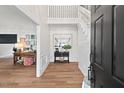 Bright foyer featuring hardwood floors, shiplap wall accent and staircase at 115 Nuttree Way, Durham, NC 27713
