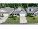 An aerial view of a well-maintained home with a manicured lawn and mature trees in a residential neighborhood at 120 Bramble Ln, Clayton, NC 27527