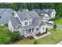 Aerial view of a two-story home with detailed roof, manicured lawn and beautiful landscaping at 122 Swansboro Ln, Chapel Hill, NC 27516