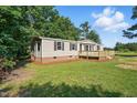 Attractive home with beige siding, a wooden deck and a well-maintained lawn at 1392 L Cooper Rd, Cameron, NC 28326