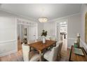 Elegant dining room features a wood table, upholstered chairs, chandelier, and hardwood floors at 1404 Kings Lassiter Way, Raleigh, NC 27614