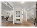 Spacious foyer with hardwood floors, neutral walls, an ottoman, and a view of the living room at 1404 Kings Lassiter Way, Raleigh, NC 27614