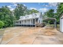 Quaint home with a metal roof, covered porch, and covered parking, blending comfort and rural charm at 1408 Old Ivey Rd, Apex, NC 27523