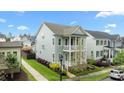 Two-story home with double porches and manicured lawn located on a tree-lined street at 1423 Tannin Dr, Durham, NC 27713