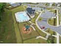 Aerial view of community amenities, including a pool, playground, and parking at 1512 Arapahoe Ridge Dr, Raleigh, NC 27604