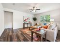 Bright living room features hardwood floors, a ceiling fan and natural light from the window at 1512 Arapahoe Ridge Dr, Raleigh, NC 27604