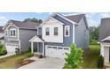 Attractive two-story home with blue siding, a two-car garage, and a well-maintained front yard at 159 Wood Orchid Ln, Garner, NC 27529