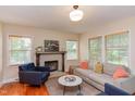 Bright living room featuring hardwood floors, neutral paint, fireplace, and lots of natural light at 1915 James St, Durham, NC 27707