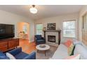 Cozy living room with fireplace, hardwood floors, and lots of natural light at 1915 James St, Durham, NC 27707