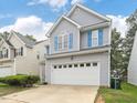 Charming two-story home with gray siding, white trim, blue shutters, and a two-car garage at 1928 Shadow Glen Dr, Raleigh, NC 27604