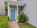 Inviting blue front door framed by white columns and a well-manicured garden at 1928 Shadow Glen Dr, Raleigh, NC 27604