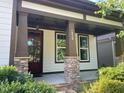 Inviting front porch with stone accents on the columns, showcasing the home's appealing entrance at 1930 Briar Chapel Pkwy, Chapel Hill, NC 27516