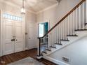 Inviting foyer with hardwood floors and staircase with white railings at 1930 Reid St, Raleigh, NC 27608