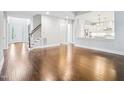Open floor plan with hardwood floors and staircase leading upstairs at 203 S South Bend Dr, Durham, NC 27713