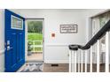 Bright entryway with hardwood floors and blue front door at 210 Dutchess Dr, Cary, NC 27513