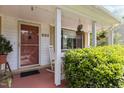 Charming front porch featuring hanging flower baskets, a rocking chair, and the house number 2125 at 2125 Cheek Rd, Durham, NC 27704