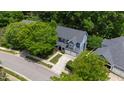 Aerial view of a two-story home with mature trees, a driveway, and a well-manicured lawn at 2309 Filigree Ct, Raleigh, NC 27614