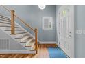 Bright entryway showcasing a modern staircase, hardwood floors, and a stylish front door at 2309 Yancey St, Raleigh, NC 27608