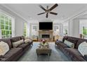 Cozy living room with a stone fireplace, plush seating, and ample natural light at 2309 Yancey St, Raleigh, NC 27608