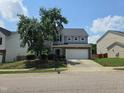 Charming two-story home featuring manicured landscaping and a spacious two car garage at 2330 Lazy River Dr, Raleigh, NC 27610