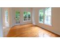 Inviting dining area with hardwood floors and view to an outdoor deck through a glass door at 2441 Deanwood Dr, Raleigh, NC 27615