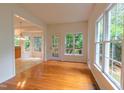 Bright dining area featuring hardwood floors, large windows, and seamless connection to kitchen at 2441 Deanwood Dr, Raleigh, NC 27615