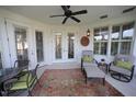 Cozy patio area with seating, stylish rug, ceiling fan, and natural light from windows and French doors at 2901 Market Bridge Ln # 203, Raleigh, NC 27608