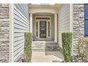 View of the front porch with a decorative glass door and neat, green manicured hedges at 2916 Reynolda Cir, Durham, NC 27712
