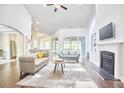 Open-concept living room with hardwood floors, fireplace, and seamless access to kitchen at 2916 Reynolda Cir, Durham, NC 27712