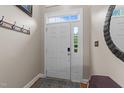 Bright entryway with a white paneled door, sidelight, transom window, and coat rack at 2921 Imperial Oaks Dr, Raleigh, NC 27614